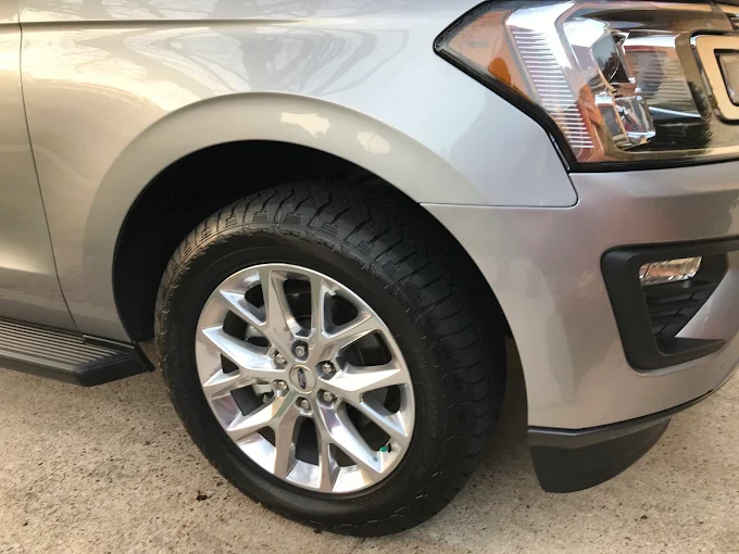 Silver vehicle front fender after repair